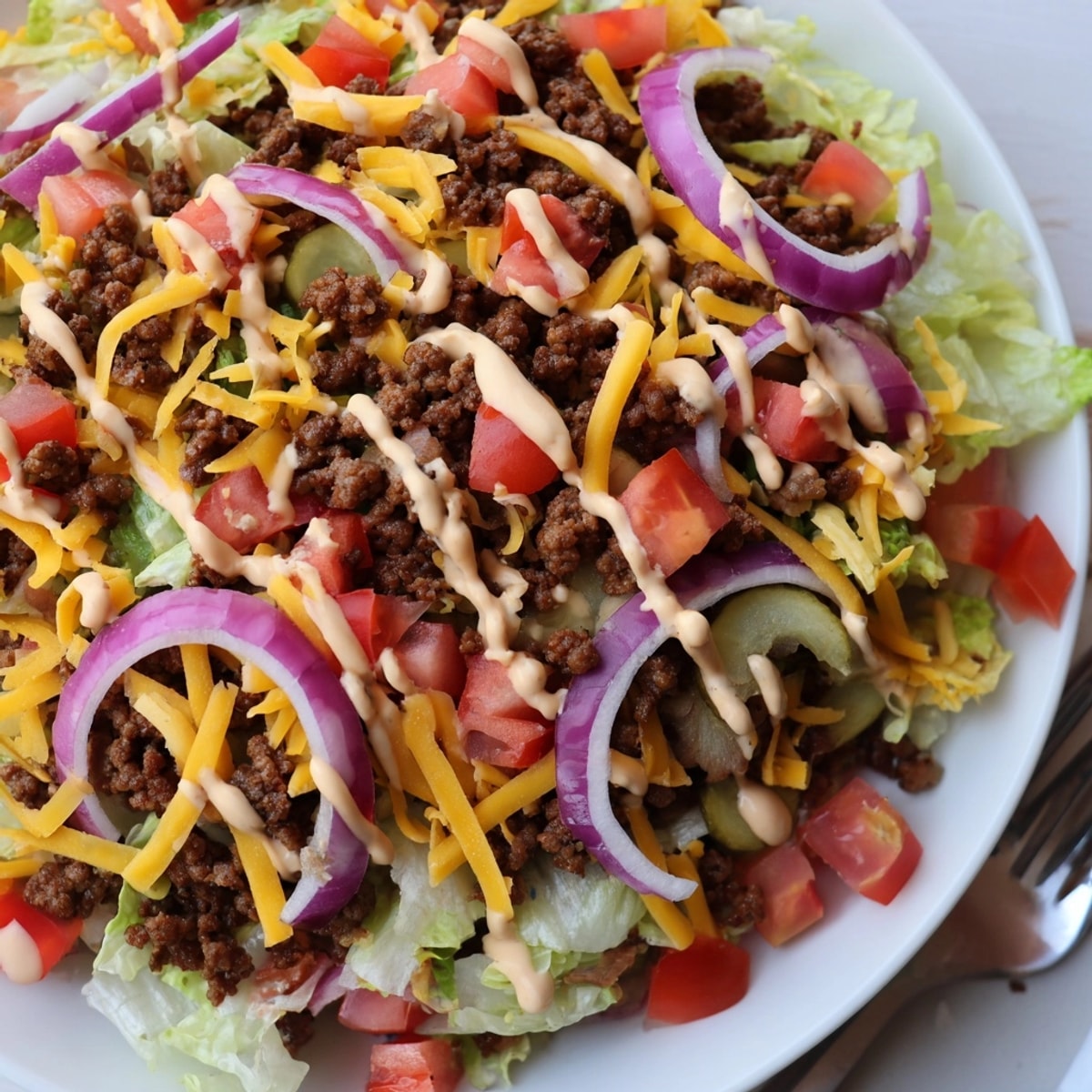 Big Mac Salad bowl: Ground beef, lettuce, cheddar, pickles, and creamy special sauce.