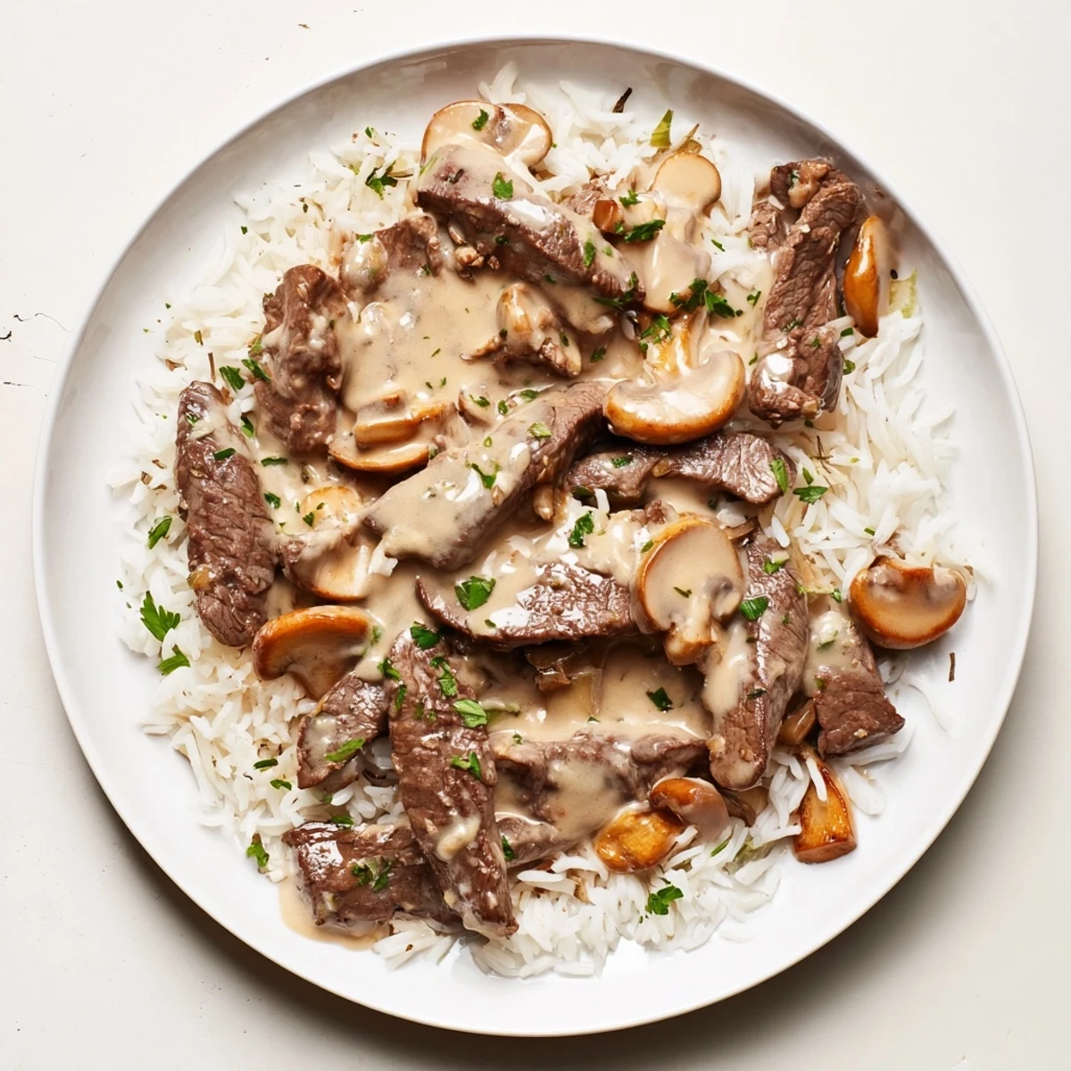 Tender Beef Stroganoff with rice, featuring a creamy, mushroom-filled gravy over fluffy rice.