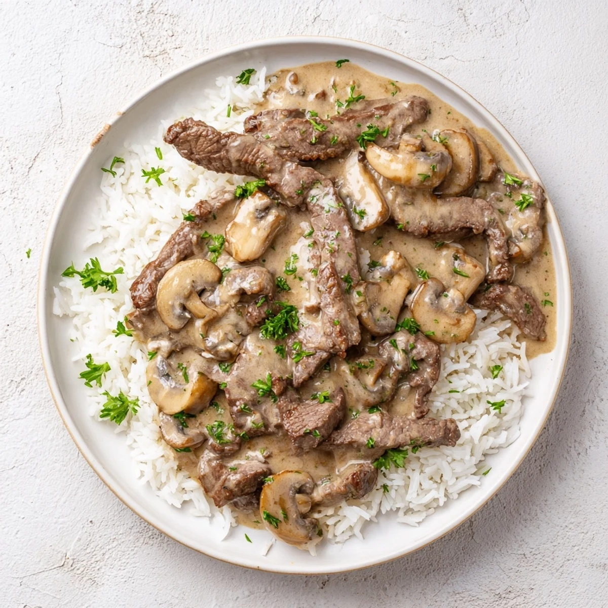 Classic Beef Stroganoff served on rice, garnished with parsley, a hearty and flavorful dinner idea.