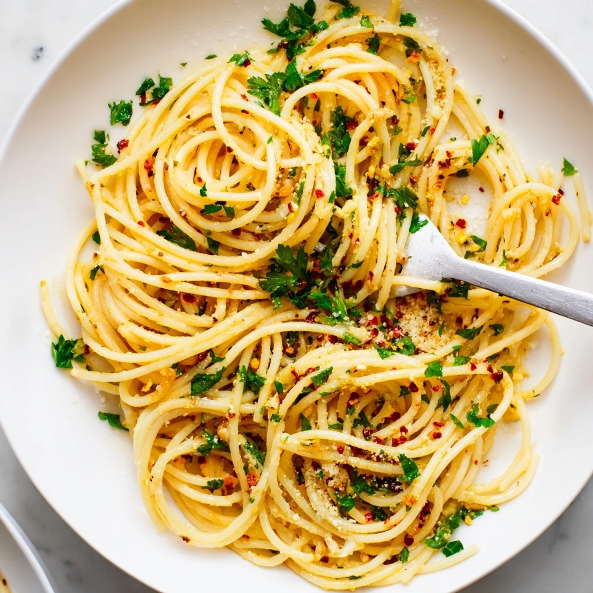 Lemony garlic pasta with fresh parsley and Parmesan, a flavorful vegetarian main course.