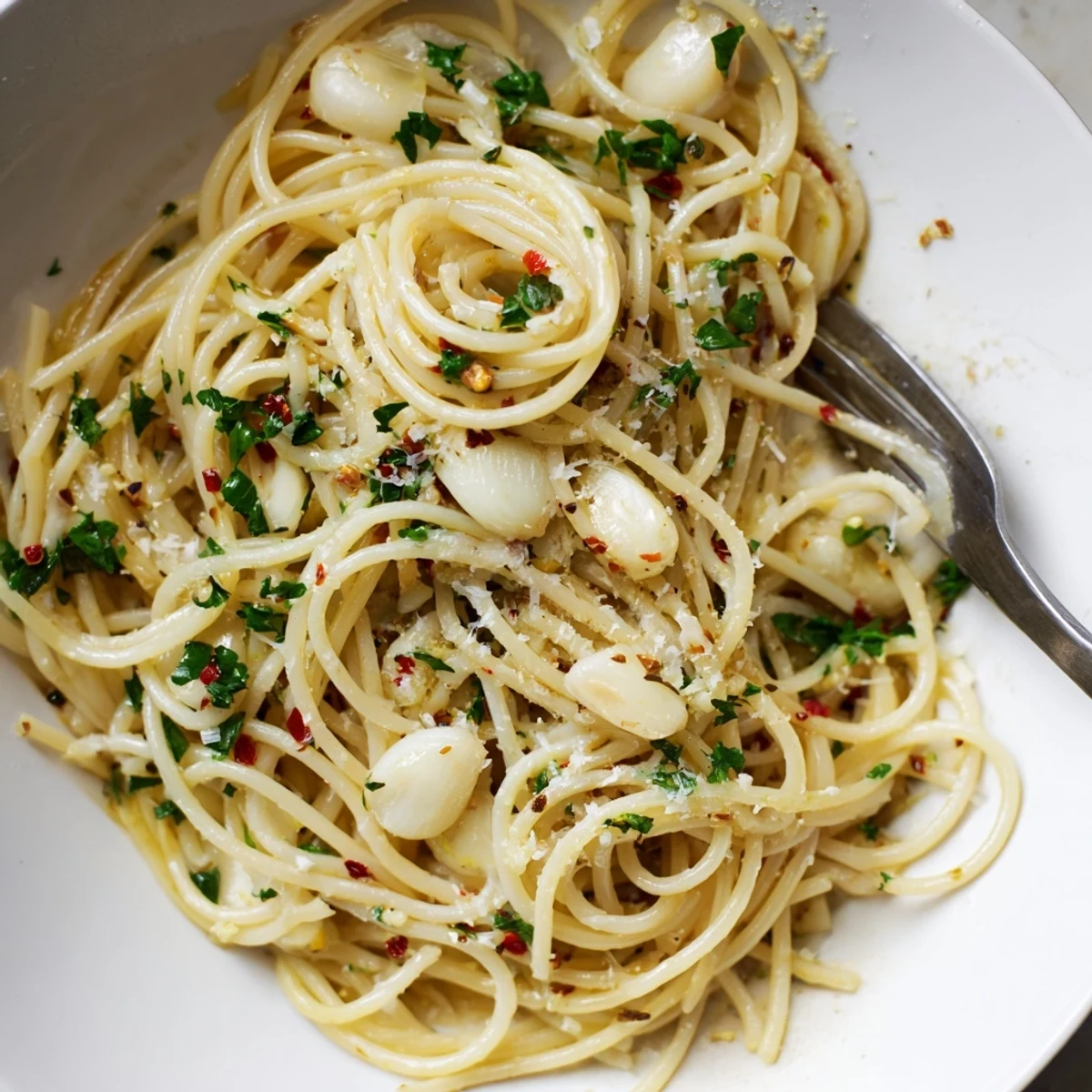 Golden garlic-infused olive oil coats perfectly cooked spaghetti in this delicious garlic pasta.