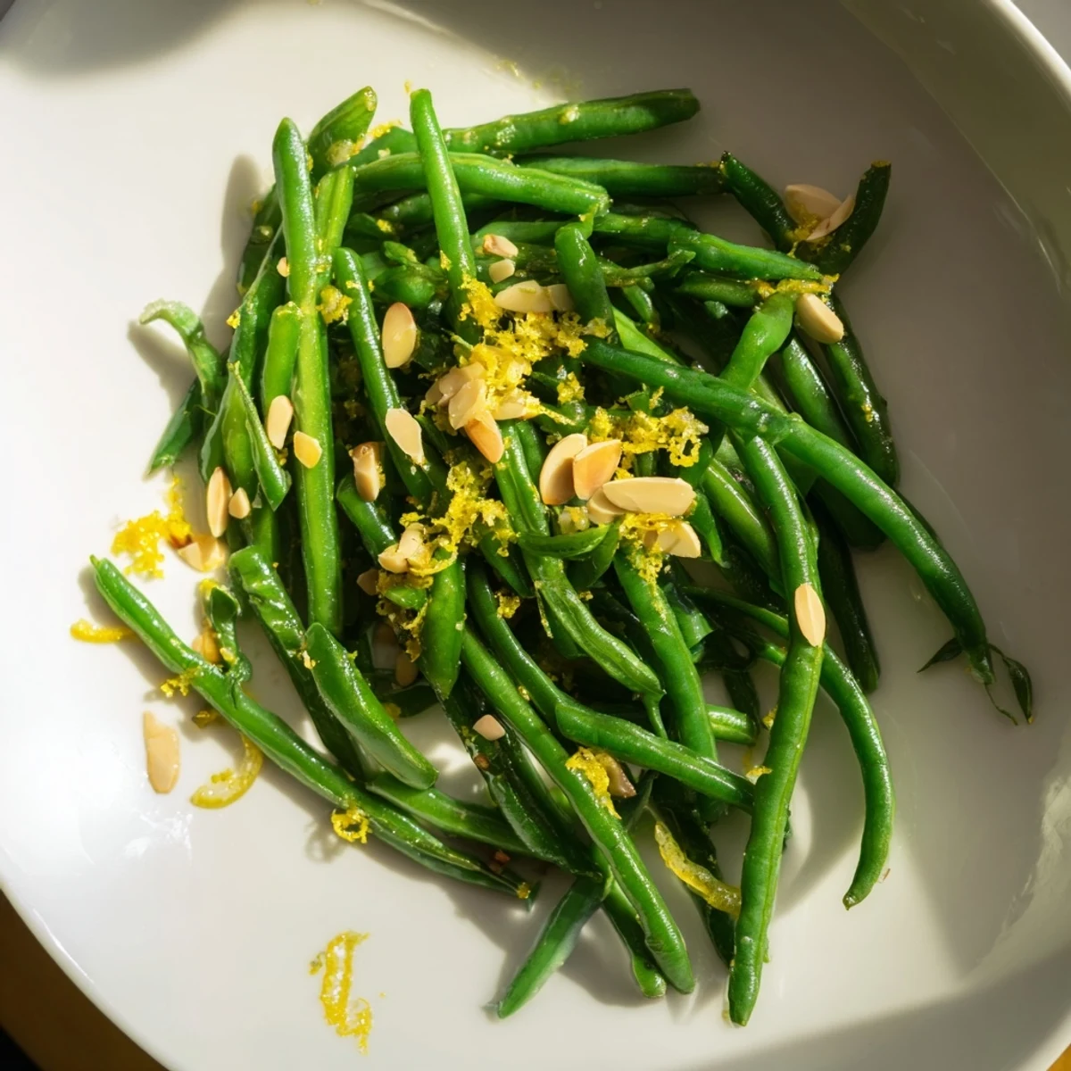 Bright green beans, tossed with lemon and garlic, creating a vibrant, savory dish.