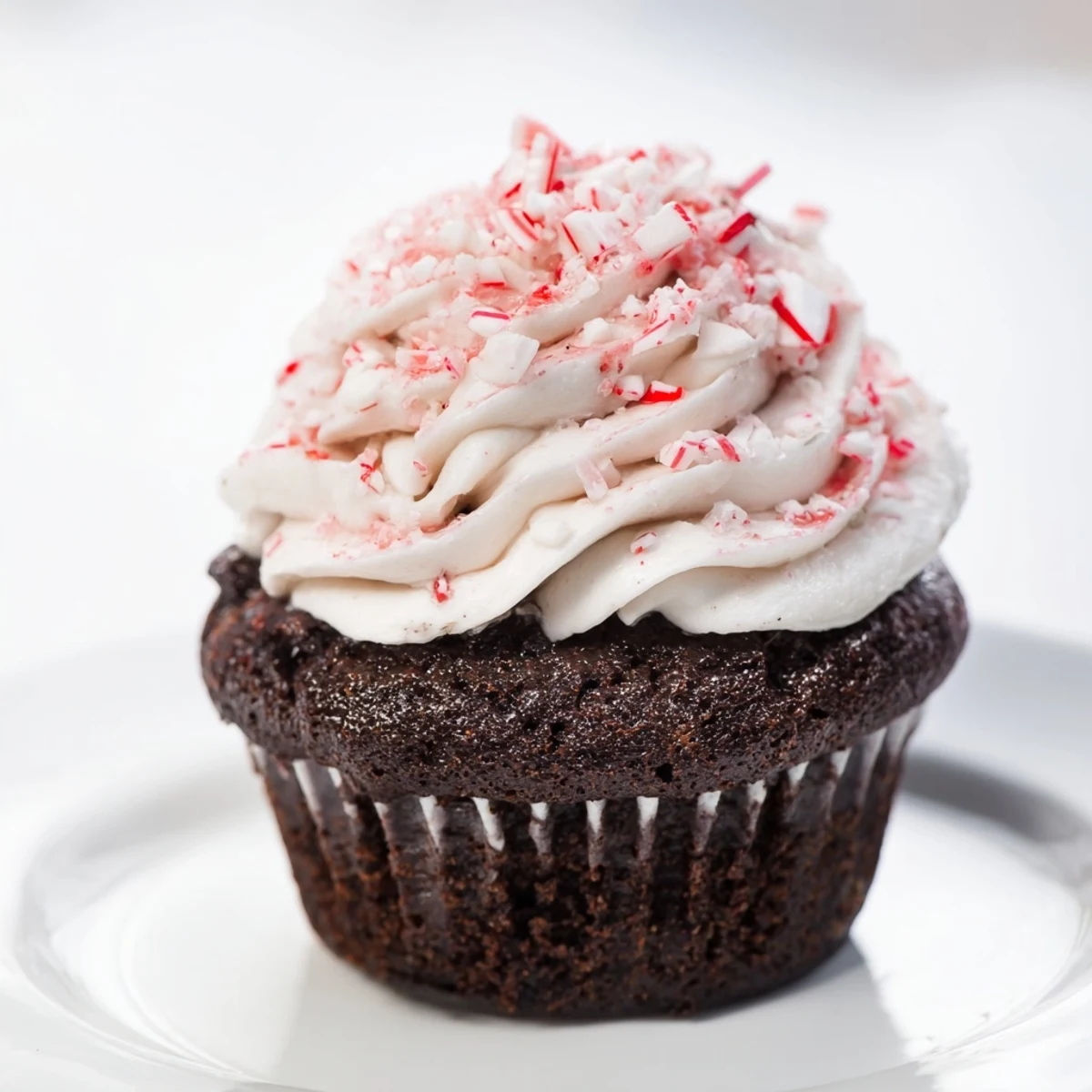 Freshly baked chocolate peppermint cupcakes, a delightful treat with creamy frosting and crushed candy cane topping.