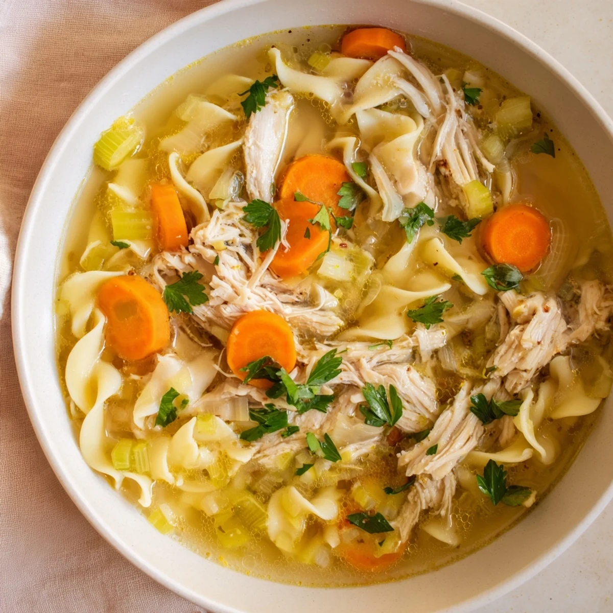 Hearty Savory Chicken Noodle Soup, garnished with parsley, perfect for a cozy, comforting American meal.