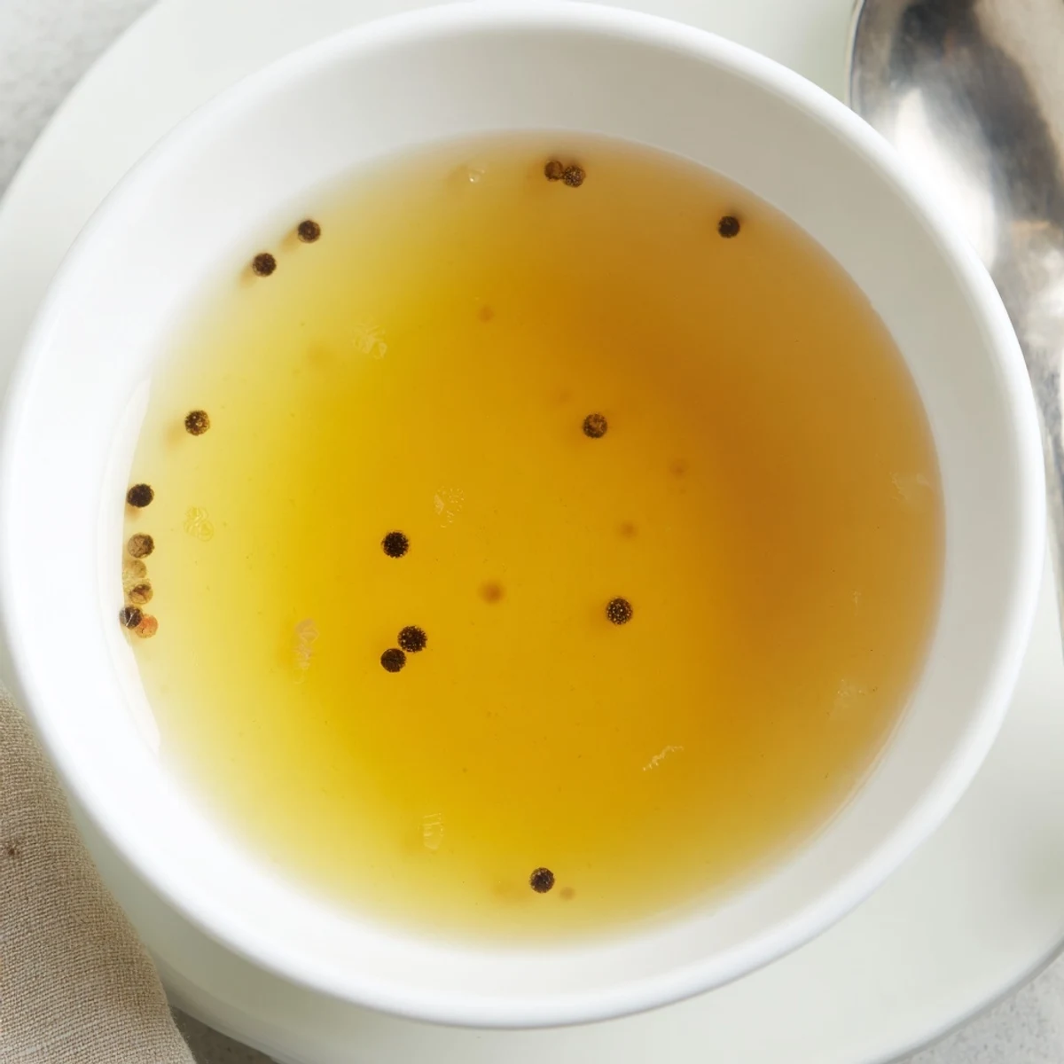 Golden brown, roasted beef bones simmering in the pot, making the perfect classic beef stock.