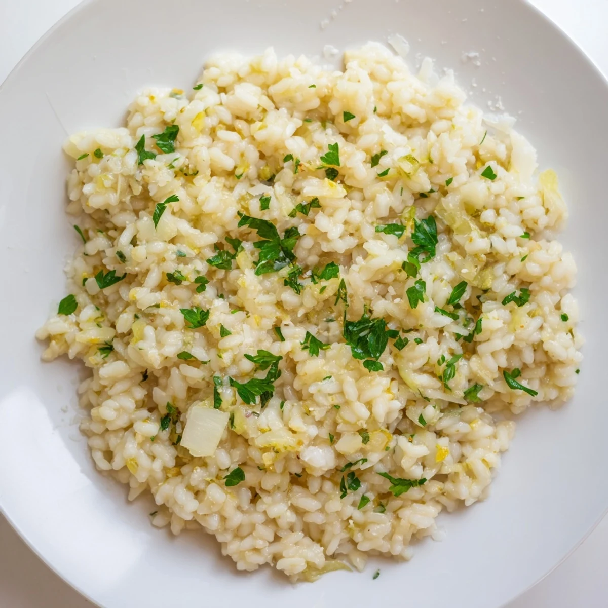 Close-up photo of creamy risotto texture, highlighting the rich cheese and flavorful white wine.
