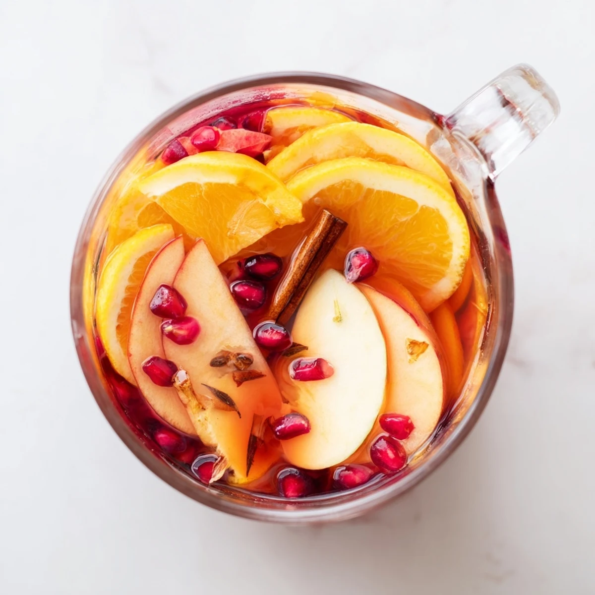 A cozy image: the vibrant orange glow of winter fruit punch, perfect for holiday parties.