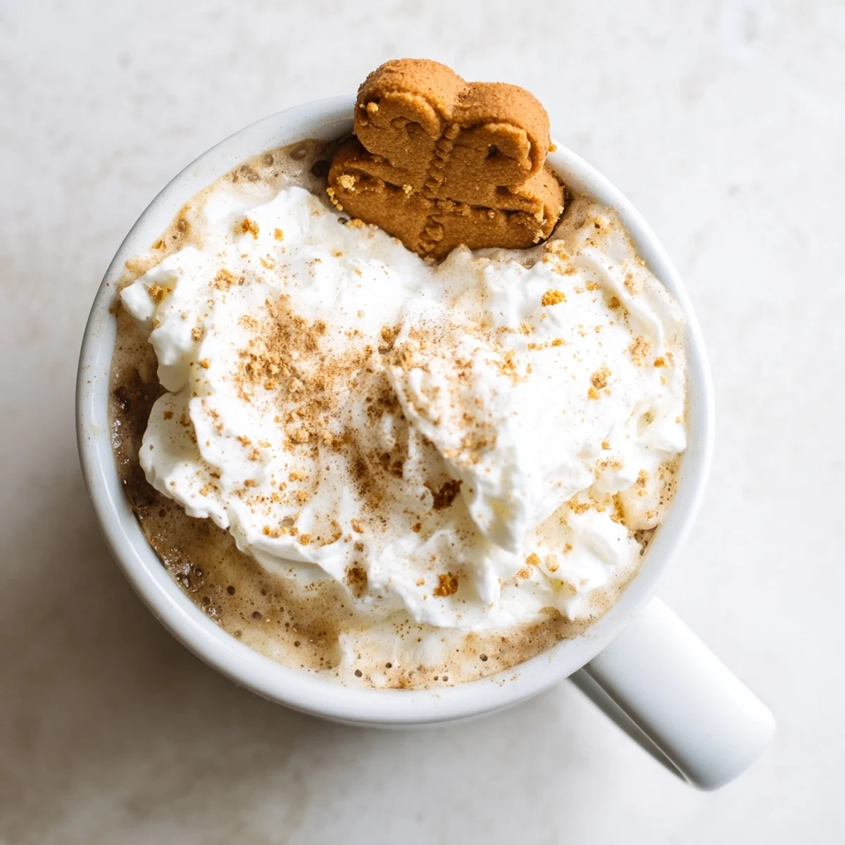 Steaming Gingerbread Latte, topped with whipped cream and cinnamon, ready to warm you up.