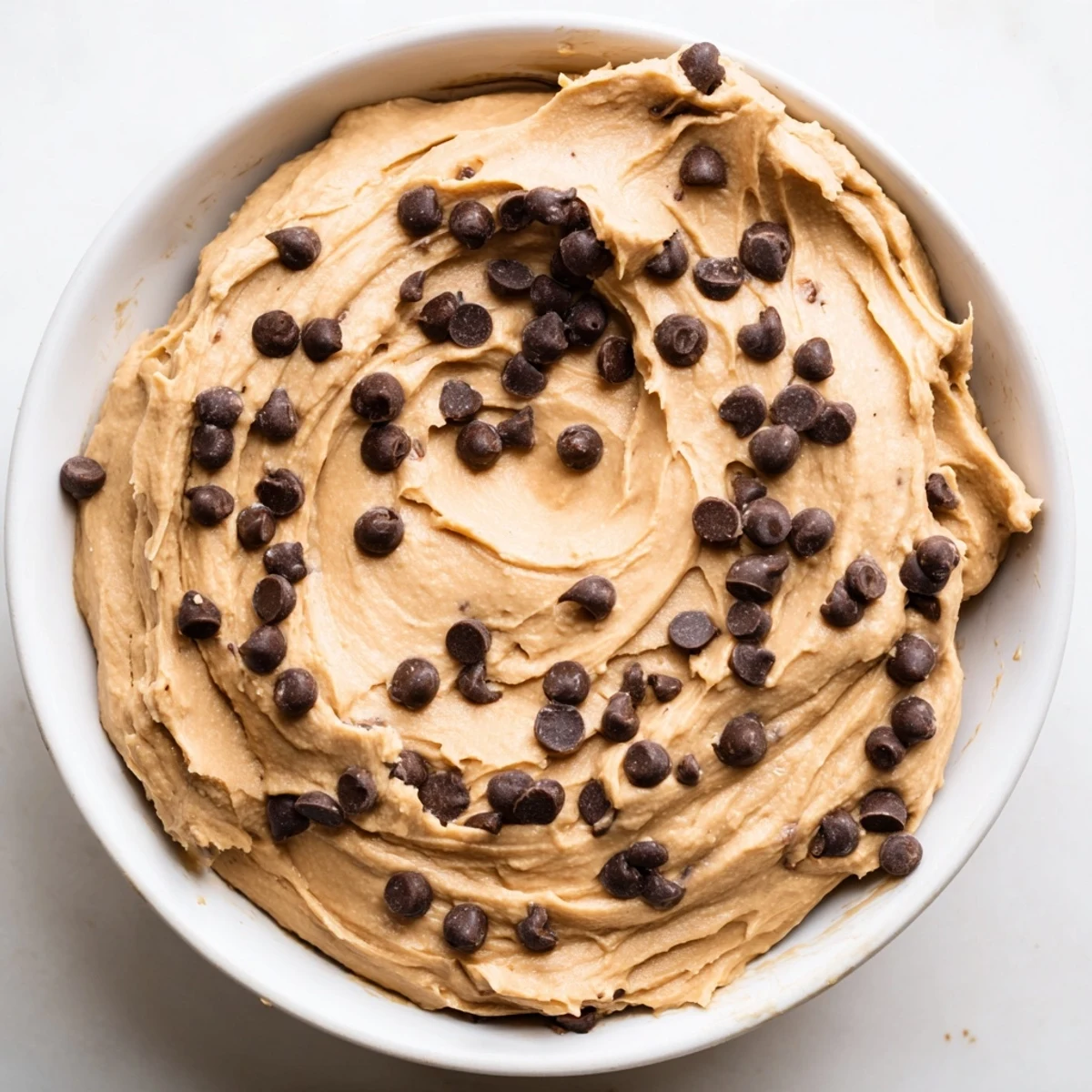 Homemade Chocolate Chip Cookie Dough Hummus served with fresh fruit and pretzels: a perfect treat!