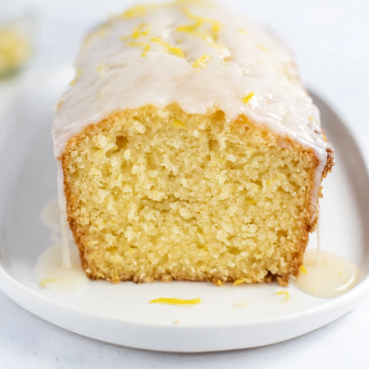 Golden brown Lemon Loaf, baked to perfection, ready to be sliced and enjoyed with tea.