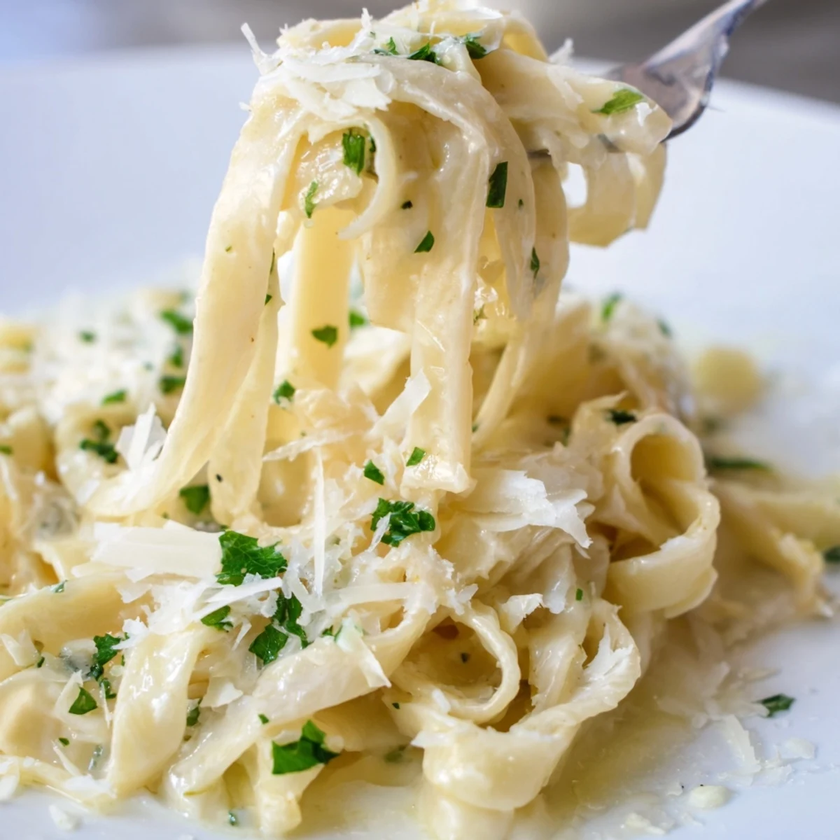 Steam rising from a skillet of Creamy Dinner Pasta, showcasing velvety sauce clinging to penne and melted Parmesan for a rich meal.