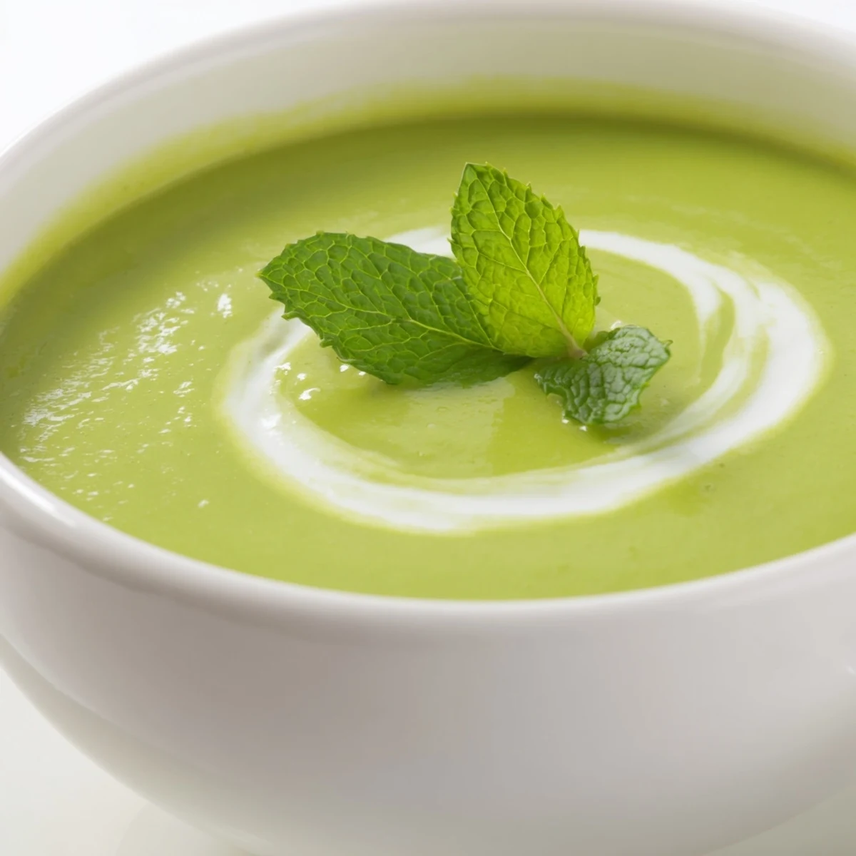 Serving of hot Green Pea and Mint Soup in a rustic bowl, paired with crusty bread for dipping.