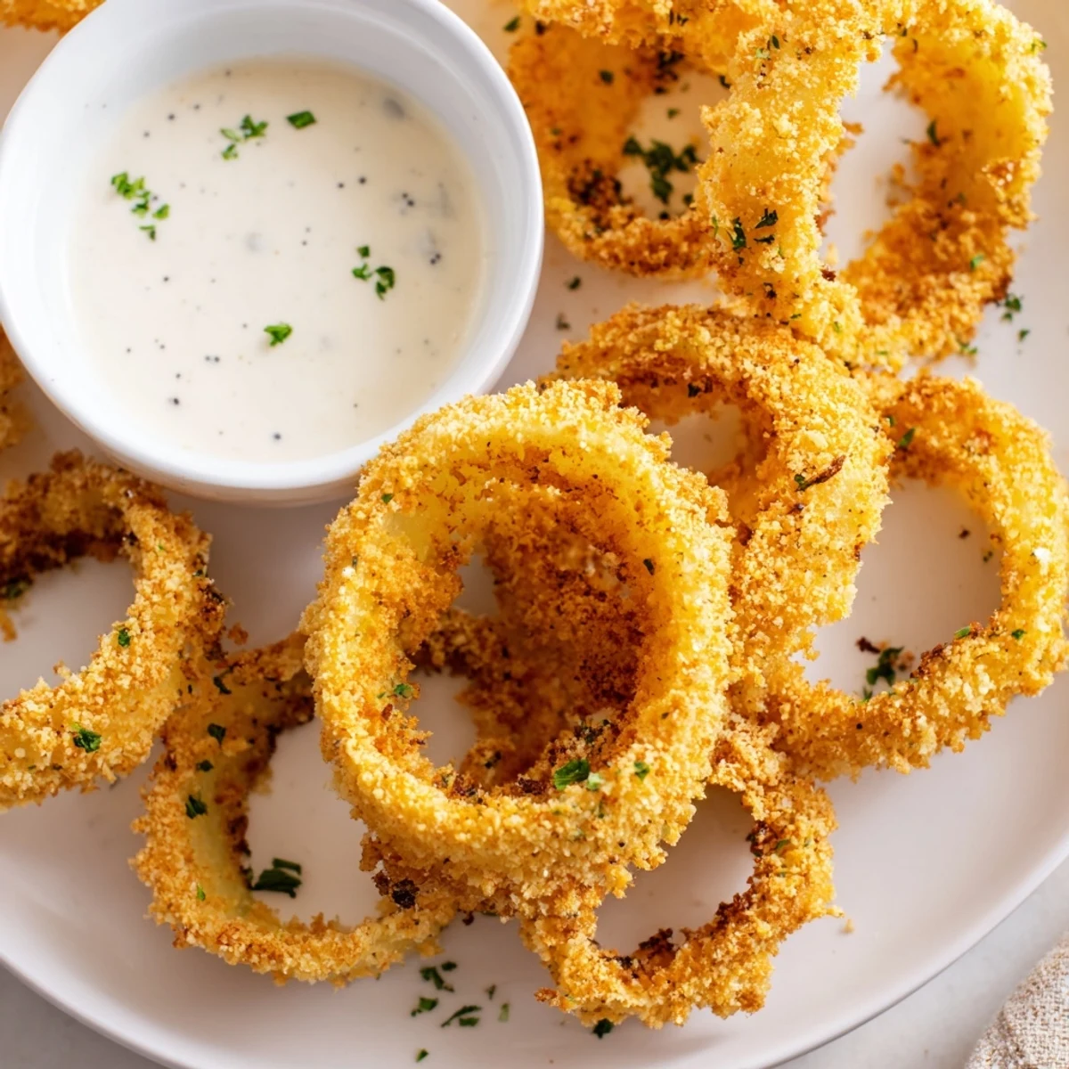 A basket of Touchdown Crispy Onion Rings with Ranch served alongside a cold beer.