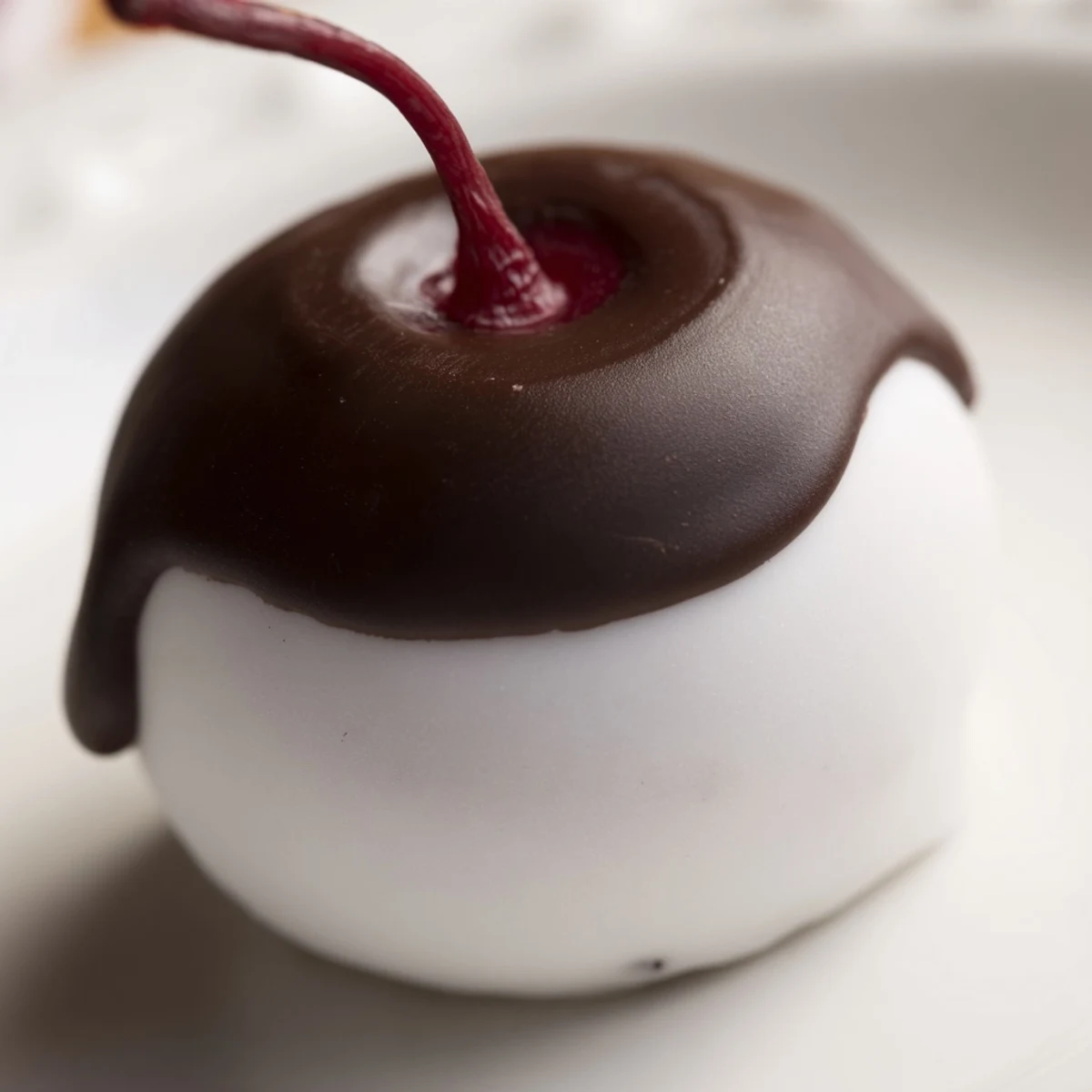 Chocolate Covered Cherries with Fondant Center stacked on a marble slab, ready to serve as an elegant homemade confection.