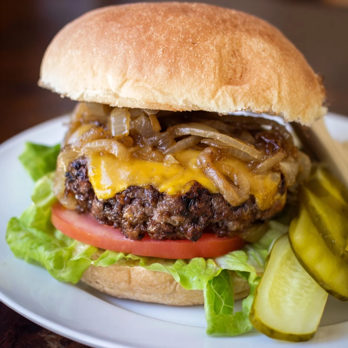 Juicy Classic Beef Burgers with Caramelized Onions, served on a toasted bun with melted cheese and fresh toppings.  