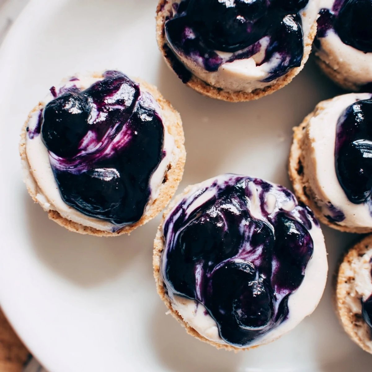 Blueberry Cheesecake Protein Bites arranged neatly with fresh berries, perfect for a healthy American dessert snack.