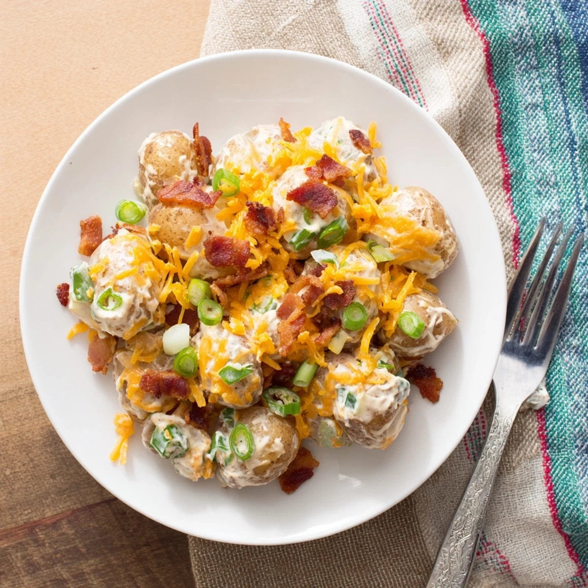 Hearty Jalapeno Popper Roasted Potato Salad served warm in a rustic bowl, garnished with fresh herbs and extra jalapeno slices.