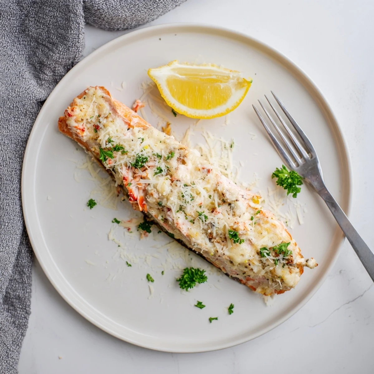 Freshly baked Crab & Shrimp Stuffed Salmon topped with melted Parmesan and fresh parsley garnish.  