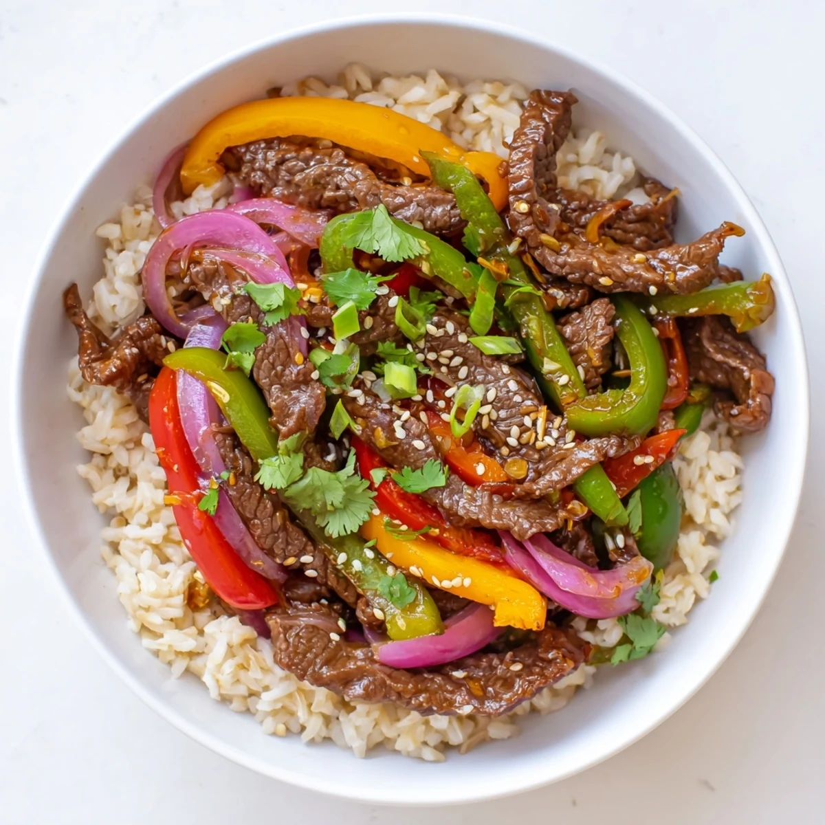 Freshly stir-fried Healthy Beef and Pepper Rice Bowl with tender beef strips and crisp colorful peppers. 