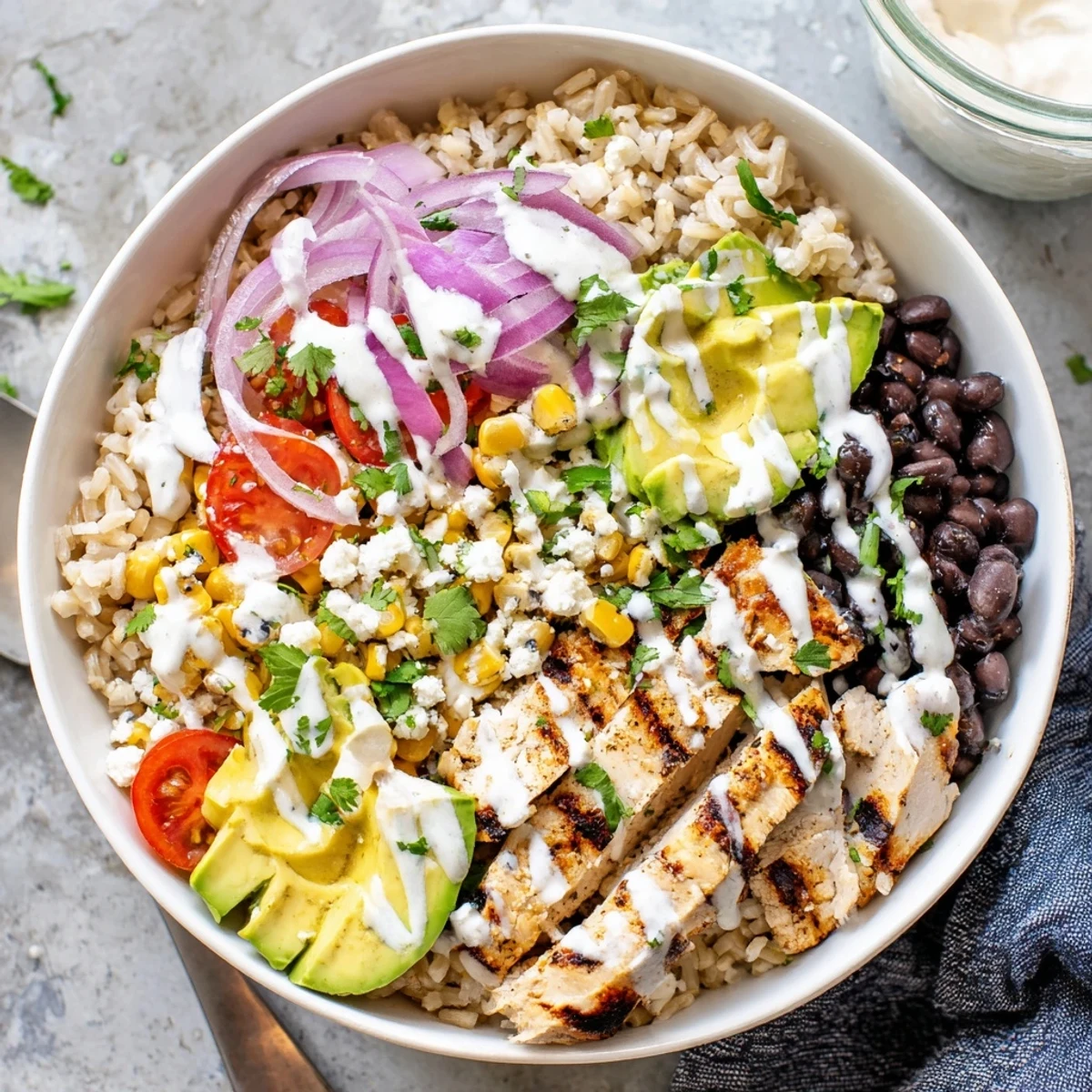 Protein packed street corn chicken bowl featuring grilled chicken, charred corn, and creamy lime dressing