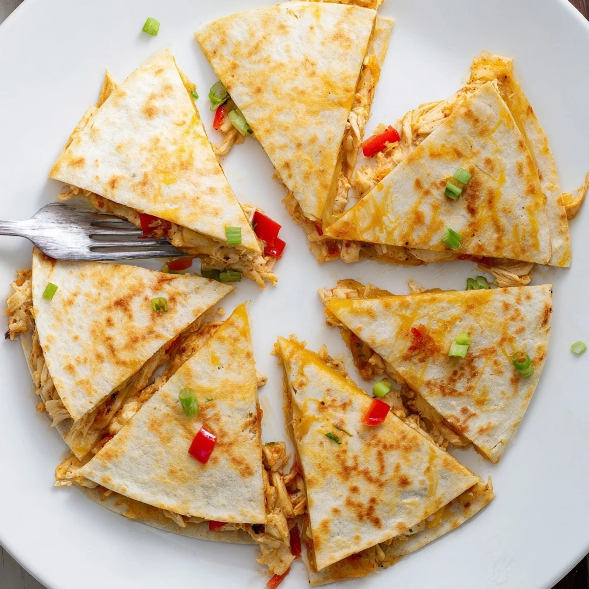 Golden baked chicken and cheese quesadillas with melted cheese and seasoned shredded chicken filling