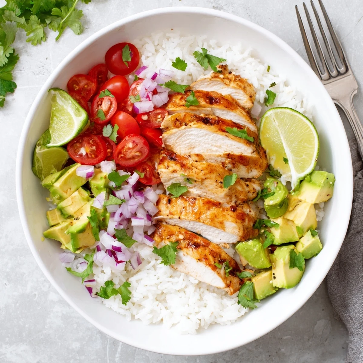 Golden honey lime marinated chicken slices arranged over creamy avocado and fluffy white rice