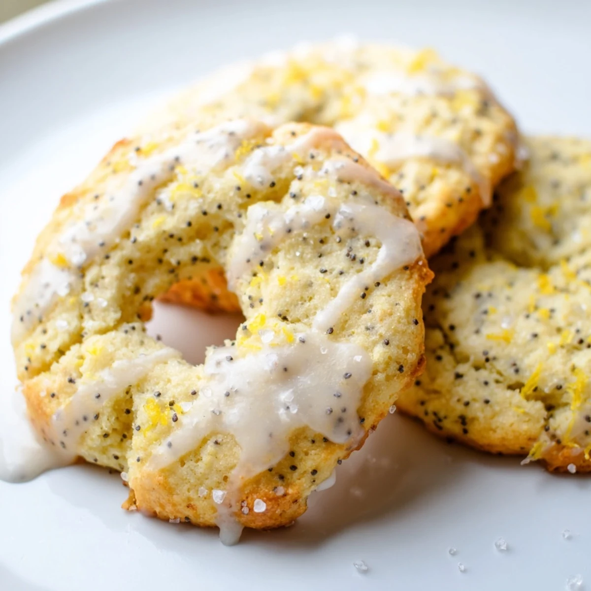 Golden lemon poppy seed cookies with crackly tops arranged on a rustic wooden serving board