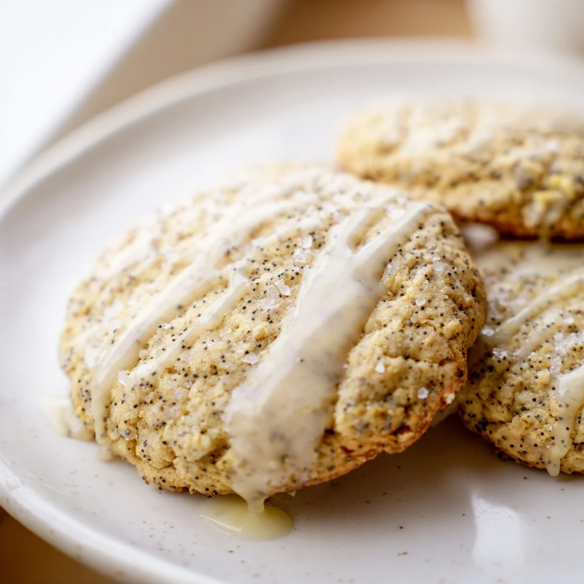 Chewy lemon poppy seed cookies drizzled with sweet citrus glaze on a cooling rack