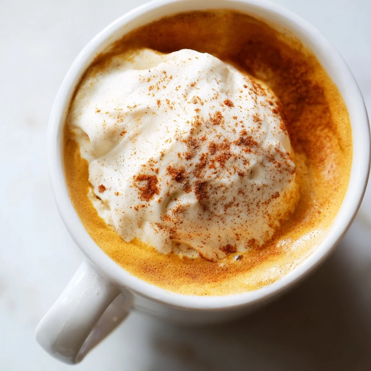 Warm homemade pumpkin spice latte served in a cozy cup with whipped topping