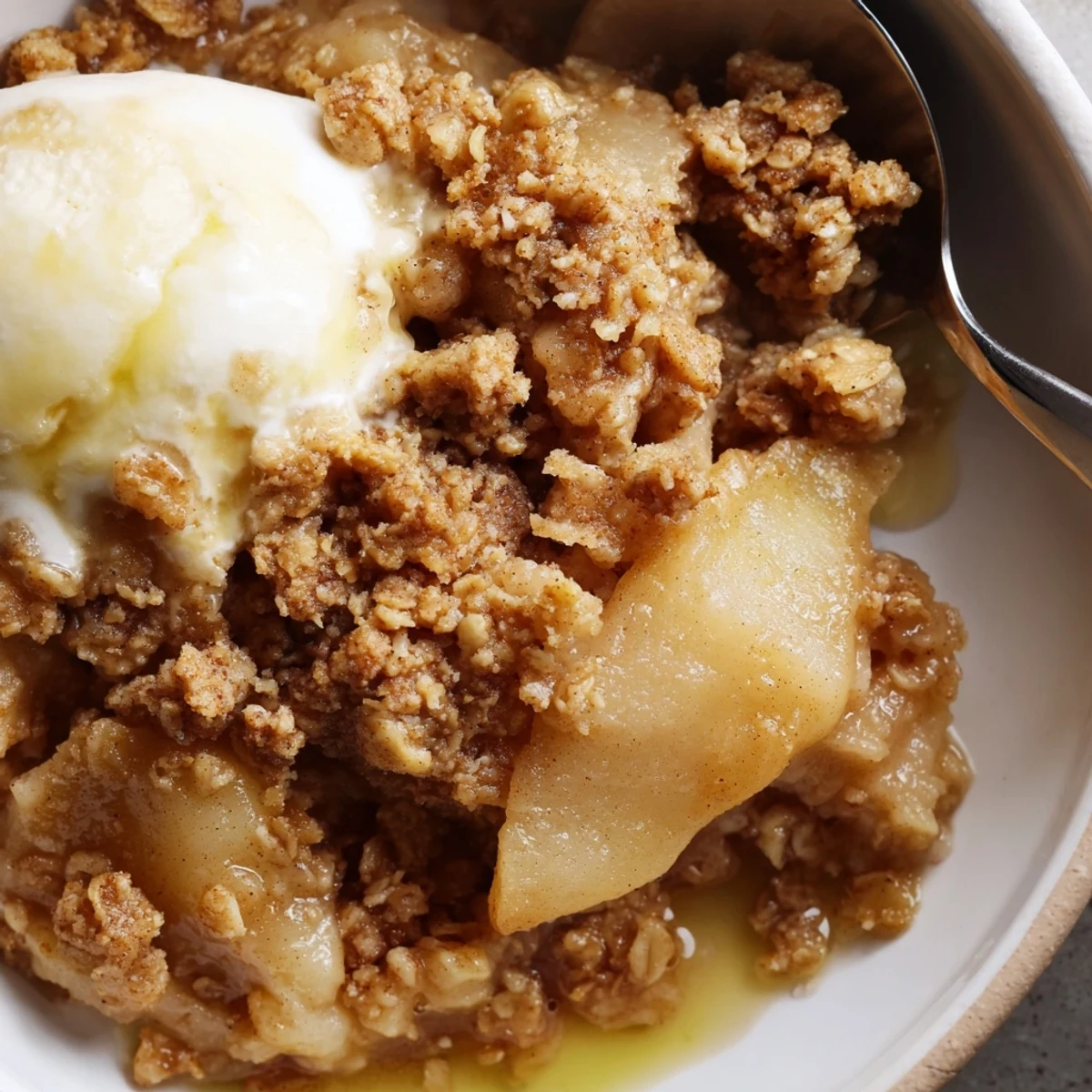 Golden cinnamon oat topping blankets tender baked apples in this warm crockpot apple crisp served in a rustic dish