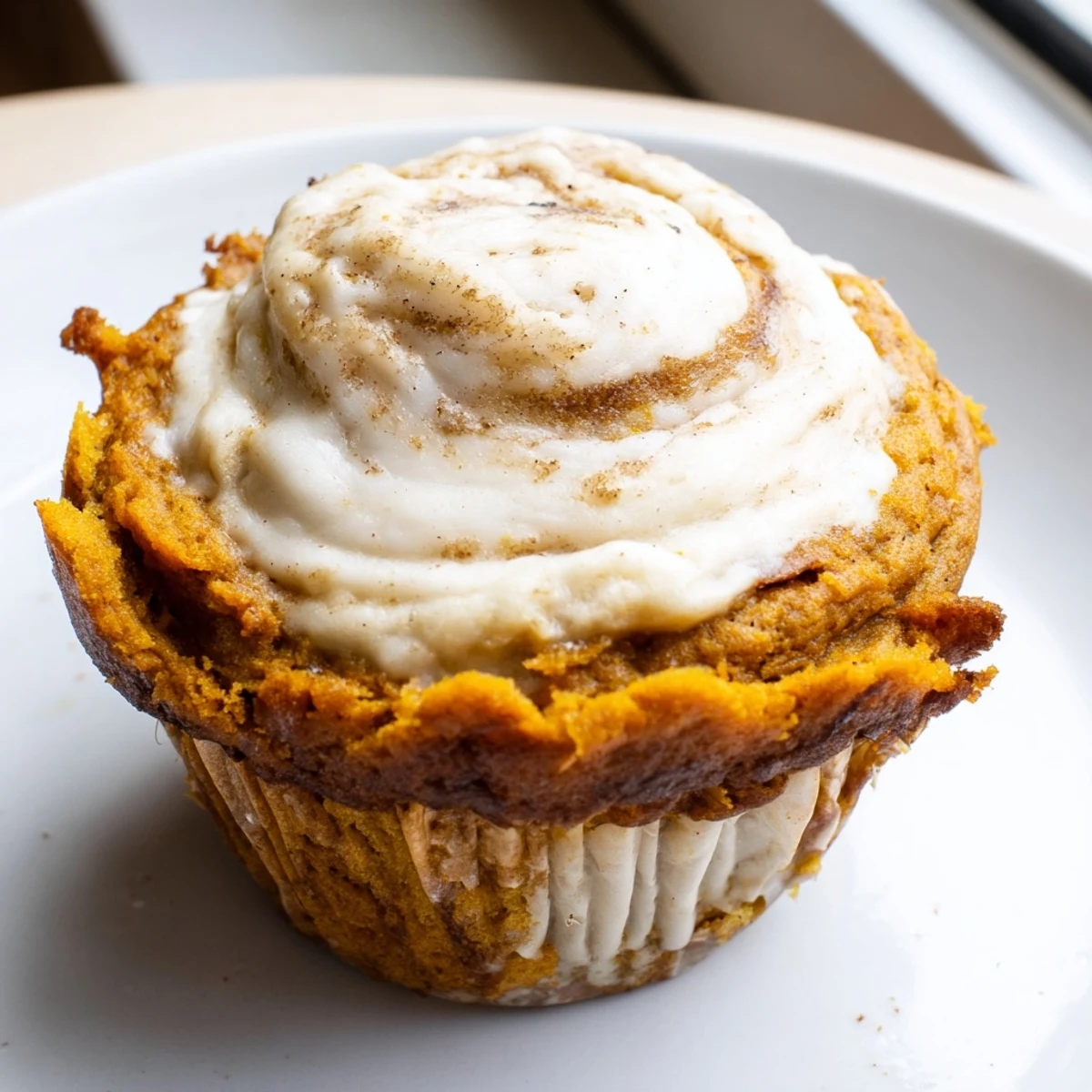 Golden chai pumpkin cheesecake muffins with swirled spiced cream cheese filling