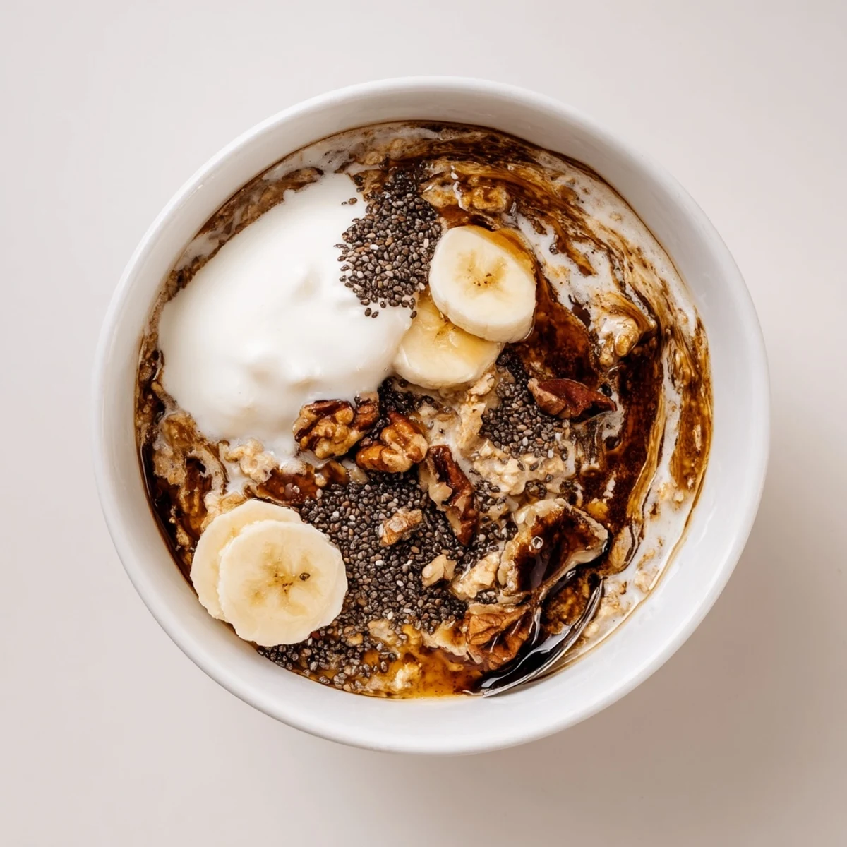 Brown Sugar Coffee Overnight Oats topped with sliced banana and toasted pecans