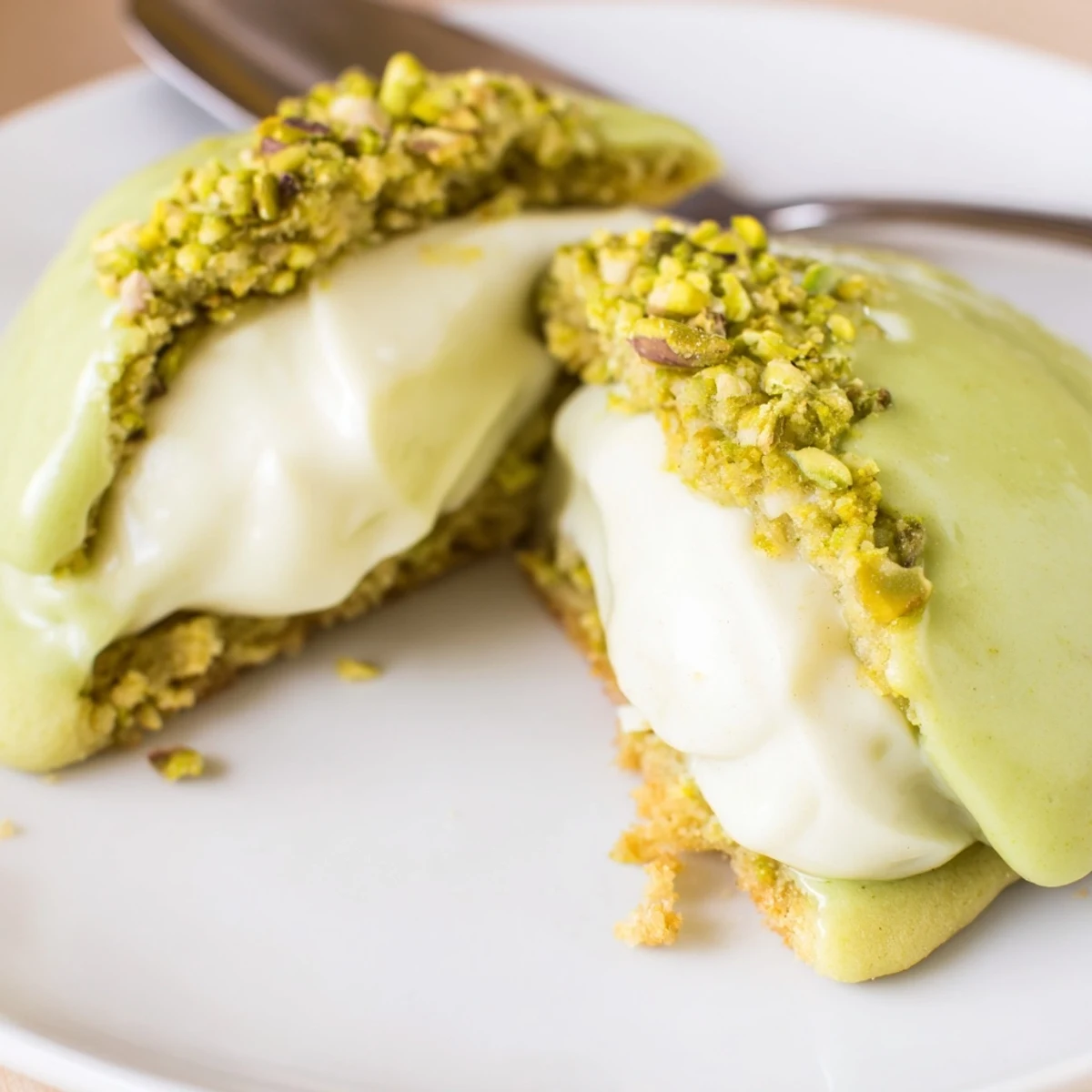Homemade Pistachio Cream Cookies rolled in chopped pistachios, crisp edges, soft center