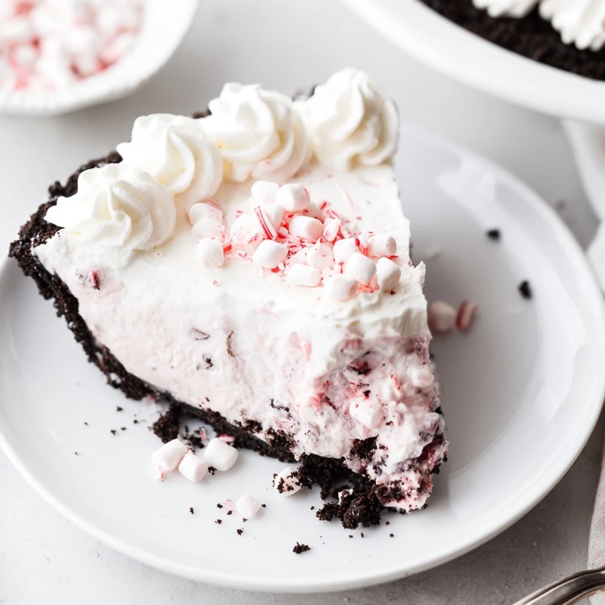 No-bake Candy Cane Pie garnished with extra crushed canes, bright peppermint aroma