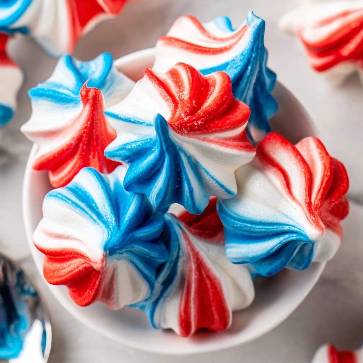 Crisp red, white, and blue Patriotic Meringue Kisses with airy light texture