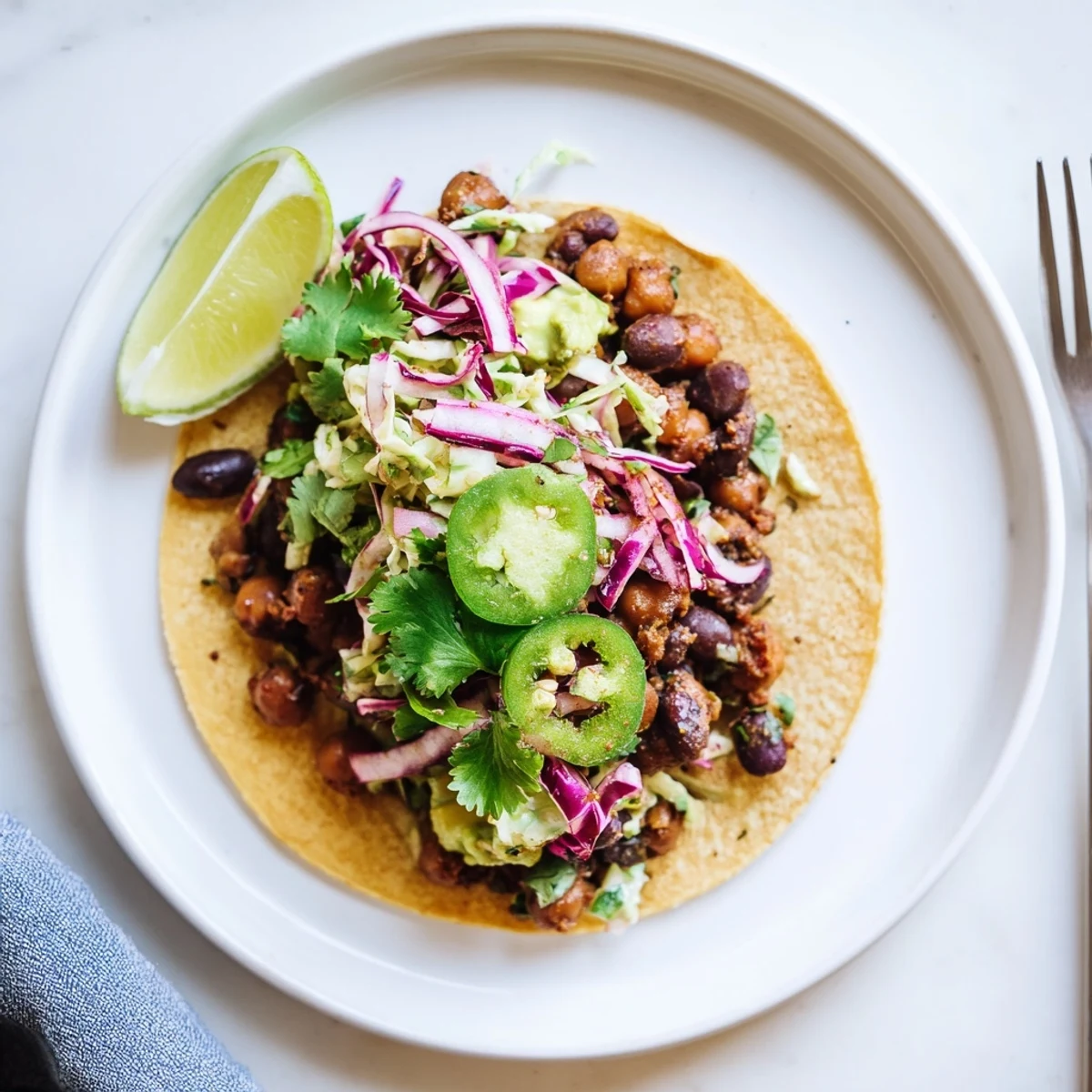 Skillet Chickpea Black Bean Tacos with Creamy Avocado Slaw and crunchy cabbage