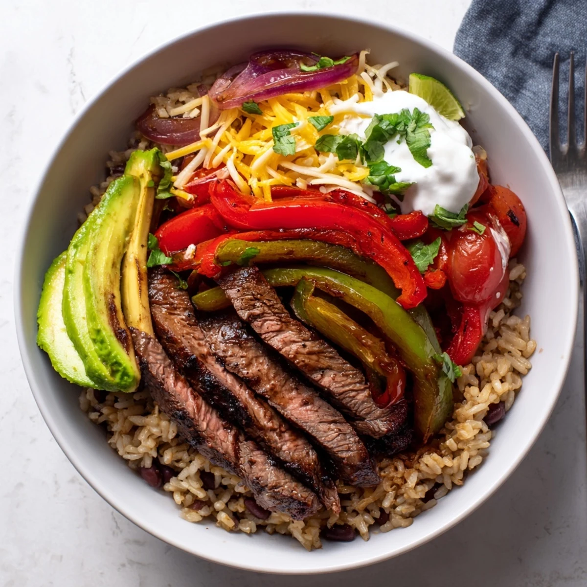 Steak Fajita Power Bowls with sizzling marinated steak, peppers, avocado slices