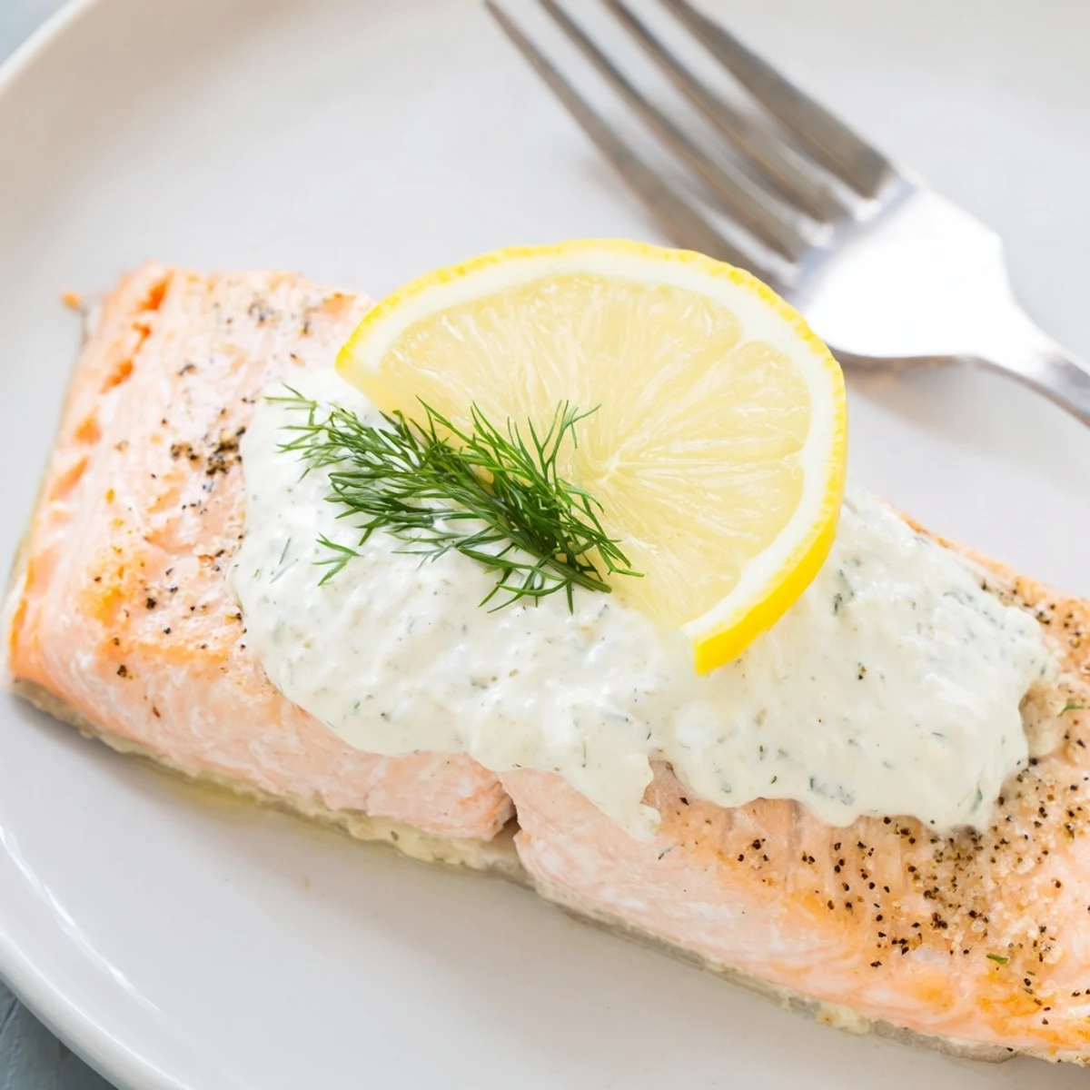 Aromatic 5 Star Baked Salmon in Garlic Dill Sauce resting on lemon slices
