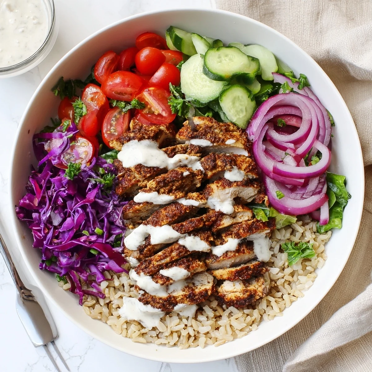 Vibrant healthy chicken shawarma bowl featuring spiced grilled chicken over colorful vegetables with creamy tahini drizzle