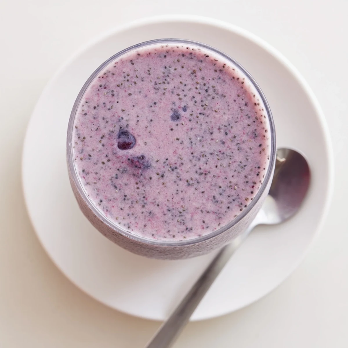Thick chia seed smoothie bowl with granola and mixed berry toppings
