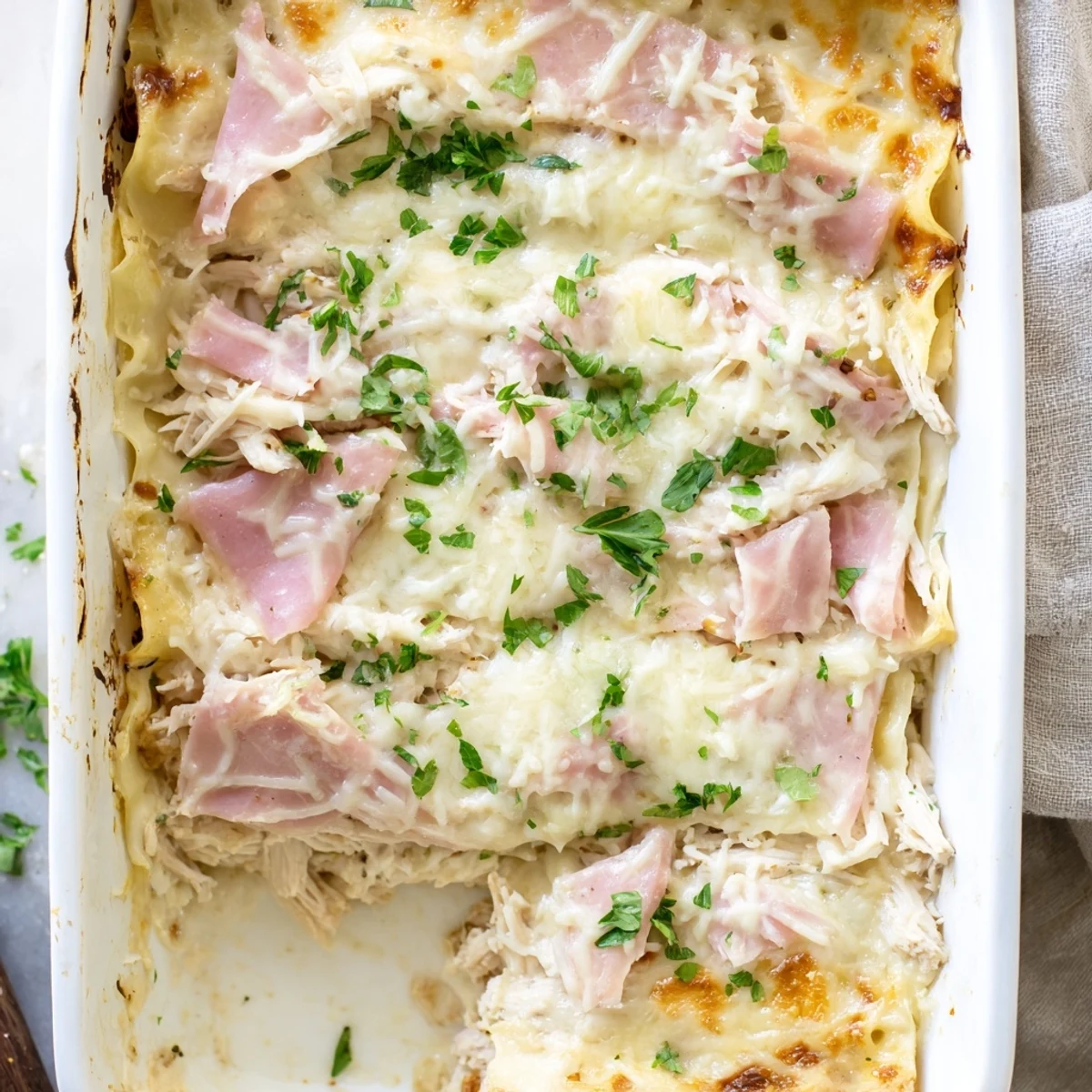 Golden bubbling Chicken Cordon Bleu Lasagna fresh from oven with melted cheese layers