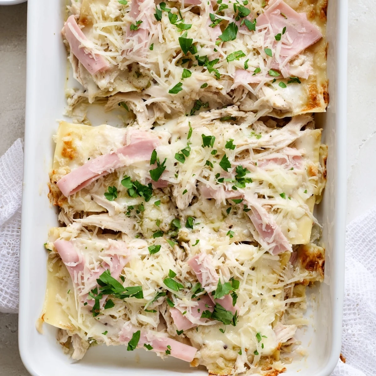 Sliced Chicken Cordon Bleu Lasagna showing tender chicken ham and creamy Swiss cheese filling