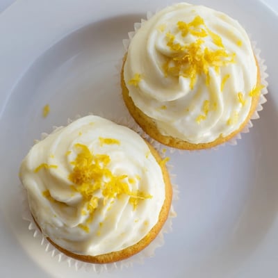 Freshly baked Limoncello Cupcakes show moist crumb and creamy frosting, perfect for a spring dessert spread.